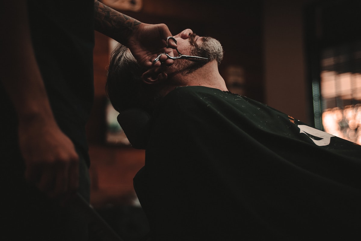 Barber working with a client